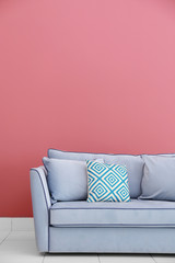 Modern couch on red wall background