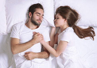 Young cute couple together in bed