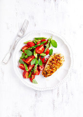 Grilled chicken breast with tomato and asparagus salad