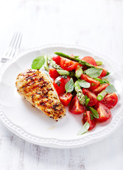 Grilled chicken breast with tomato and asparagus salad
