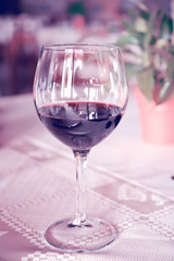 glass of wine on the table, light toning