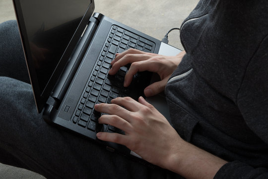 Boy hacking on laptop