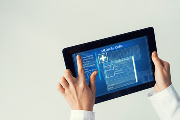 Close of female doctor hands working with tablet pc computer