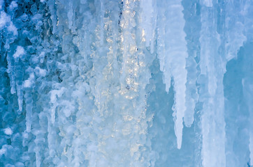 blue ice and frozen icicles, winter background