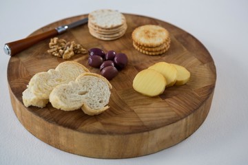 Fototapeta na wymiar Bread, crackers, olives, walnut and knife on 