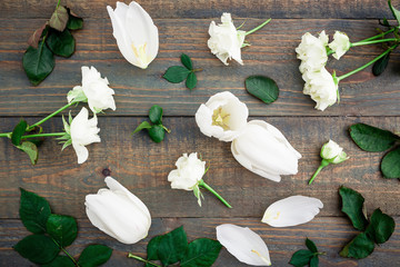 Valentines Day background. Floral pattern made white flowers, green leaves, branches on wood background. Flat lay, top view. Valentine's background