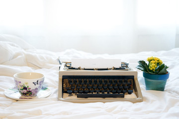 Vintage typewriter on  the bed