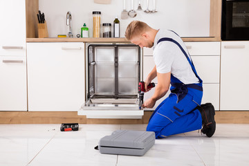 Repairman Repairing Dishwasher