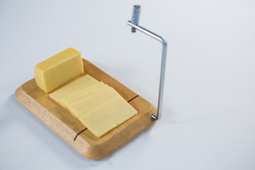 Cheese cutting board with slices of cheese