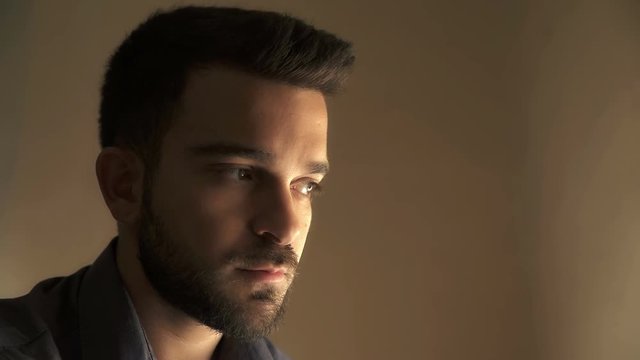 young guy with  beard looks ahead