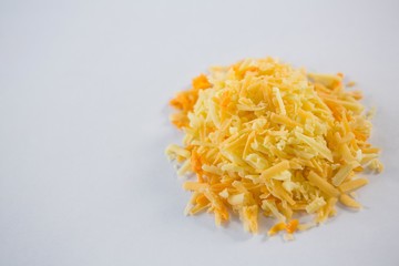Heap of grated cheese on a white background