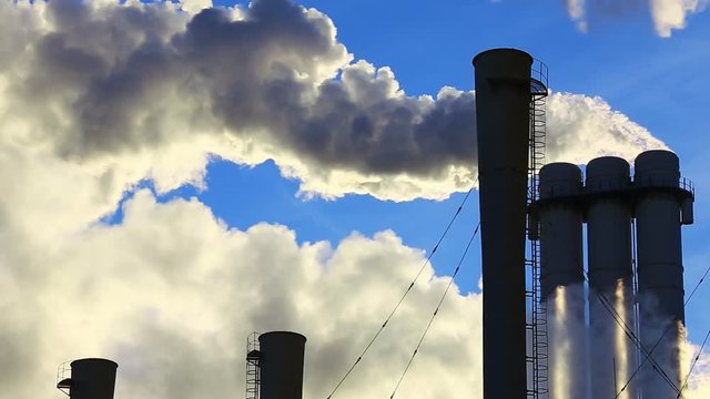 Smoke stacks at gas burning power plant in in cold weather