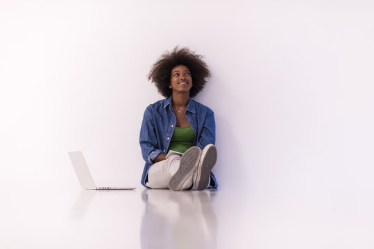 african american woman sitting on floor with laptop