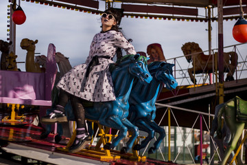 Cute pinup girl on a carousel