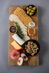 cheese with olives, peach, honey, rosemary
