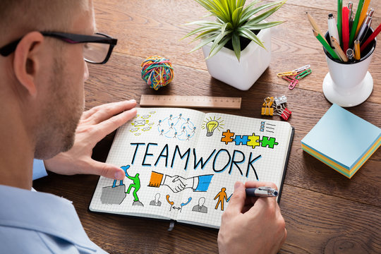 Teamwork Concept On Notebook