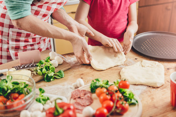 Mother and daughter preparing pizza