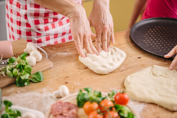 Mother and daughter preparing pizza