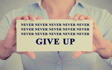 Businesswoman hands holding card with never give up sign message