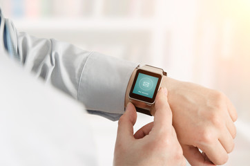 Man using smartwatch with e-mail notifier