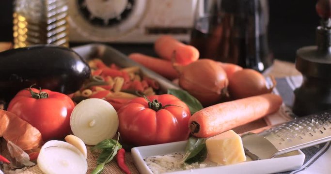 Dolly sliding view of  Italian pasta and ingredients for tomato sauce