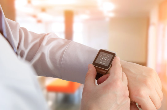 Man using smartwatch with e-mail notifier