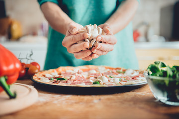 Woman preparing pizza
