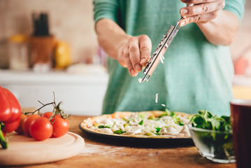 Woman preparing pizza