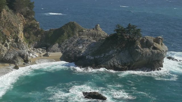 Panning and zooming out view of McWay Falls in the Big Sur area of Central California.