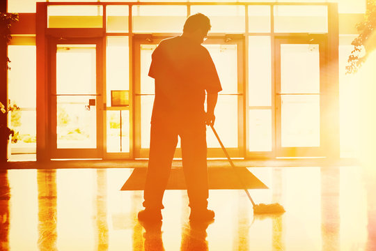 Janitor Mopping In An Office