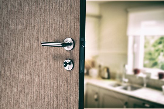 Composite image of closeup of door with doorknob and key