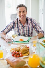 Happy man having meal on dinning table