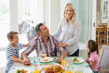 Family having meal on dinning table at home