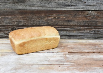 Homemade loaf of  bread on wood table with copy space.