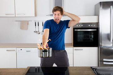 Surprised Man Holding Utensil On Fire