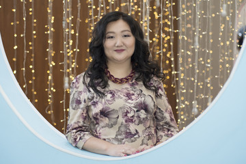 Full Asian woman on the background of glowing lights.