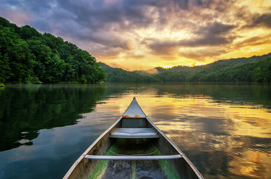 Summer sunset, mountain lake, aluminum canoe