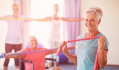 Portrait of seniors exercising with stretching bands