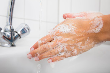 Woman Washing Hand In The Basin