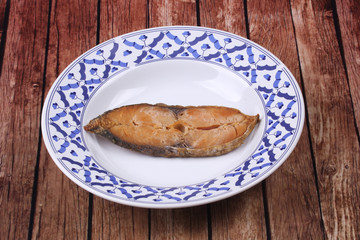 Deep-fried dried salted spotted mackerels in Thai pattern dish.