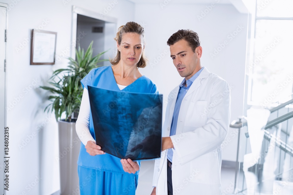 Canvas Prints Two doctors looking over patients x-ray in corridor