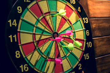 The darts on a wooden background.vintage
