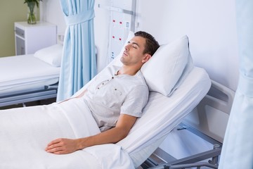 Male patient sleeping on bed