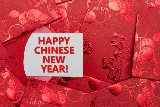 red pockets with a card written happy chinese new year
