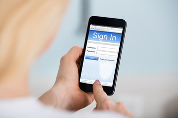 Woman Signing Into Website On Mobilephone