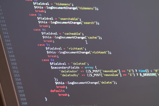 JavaScript code write on the laptop's display with dark background