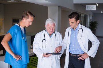 Doctors discussing over clipboard