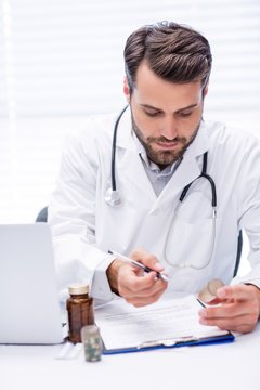 Male doctor checking medicine