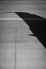 Silhouette of an airplane wing on the runway