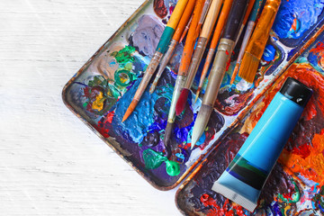 paintbrush  palette on the wooden floor.